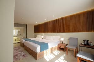 Voodi või voodid majutusasutuse Pyramid Front Hotel toas