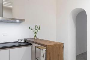 una cocina con una encimera de madera con un jarrón. en San Frediano Elegant, en Florencia 23 fotos más