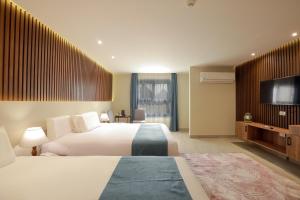 Voodi või voodid majutusasutuse Pyramid Front Hotel toas