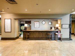 a lobby with a bar with stools at Kishigon Ryokan in Shibukawa +64 photos