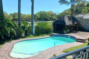 a swimming pool in a yard with a gazebo at Dreamers Guesthouse - NO LOADSHEDDING in King Williamʼs Town