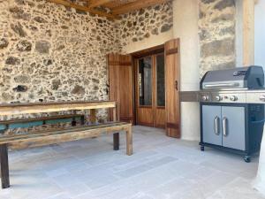 a kitchen with a stove and a bench in a room at Meraki Apartments Crete in Plakias