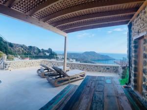 a patio with a view of the ocean at Meraki Apartments Crete in Plakias