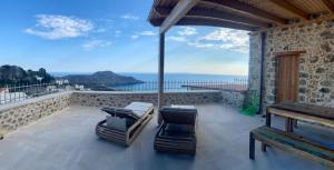 a balcony with chairs and a view of the ocean at Meraki Apartments Crete in Plakias
