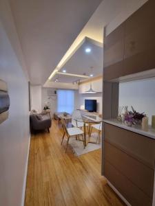 a kitchen and living room with a table and a couch at Casa de Rosand in Cebu City
