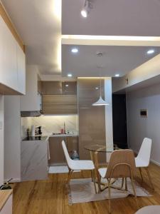 a kitchen and dining room with a glass table and chairs at Casa de Rosand in Cebu City