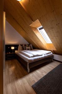 a bedroom with a bed in a attic with a window at Landhofmühle in Eltendorf