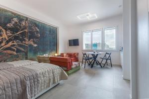 a bedroom with a bed and a table and chairs at Bologna Tecnopolo Utamaro apartment in Bologna