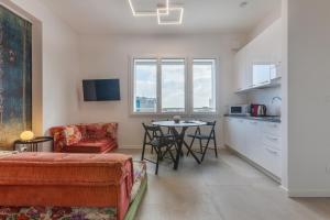 a living room with a couch and a table at Bologna Tecnopolo Utamaro apartment in Bologna