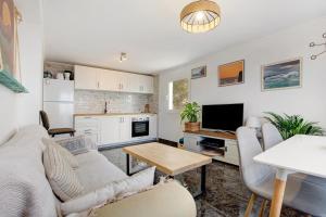 a living room with a couch and a table at El Cotillo Mar Beach in El Cotillo