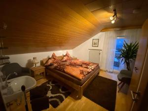 a bedroom with a bed and a sink and a tub at Haus Heidi in Freyung