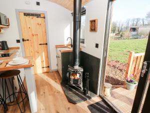 a wood burning stove in a tiny house at The Queen Bee in Pembroke