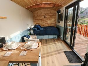 a living room with a table and a couch at The Bumblebee in Pembroke