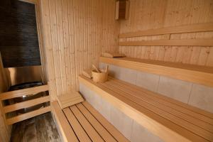 a sauna with wooden paneling and a bench in it at Glamping Alliance Hotel in Plovdiv