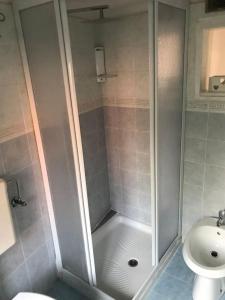 a bathroom with a shower and a toilet at Casa Aurora in Baveno