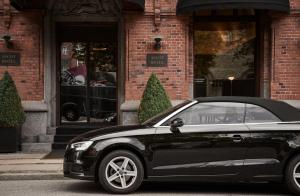 a black car parked in front of a building at Hypernym Hotel & Suites in Copenhagen