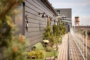 a row of chairs on a balcony with a lighthouse at Hypernym Hotel & Suites in Copenhagen