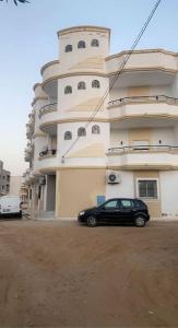 a black car parked in front of a building at Outstanding Two bedroom Apartment in Sahline
