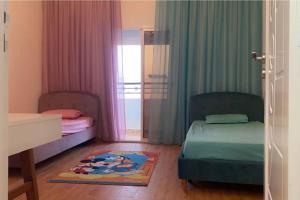 a small bedroom with two beds and a window at Outstanding Two bedroom Apartment in Sahline