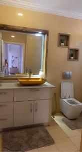 a bathroom with a sink and a toilet at Outstanding Two bedroom Apartment in Sahline