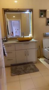 a bathroom with a sink and a mirror at Outstanding Two bedroom Apartment in Sahline
