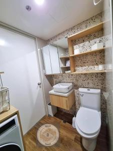 a small bathroom with a toilet and a sink at Casa de Rosand in Cebu City +6 photos