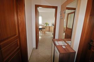 a hallway with a door and a table in a room at Apartment Branka in Premantura