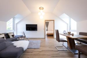 a living room with a couch and a table at Landhofmühle in Eltendorf