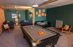 a living room with a pool table in a room at CHALET AUBERGE - Les Mélèzes in Tignes