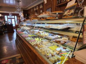 a display case filled with lots of different pastries at b&b Vallone del grano in Rossano