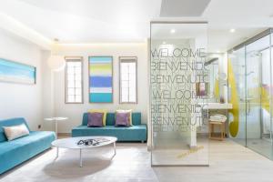 a living room with a blue couch and a glass wall at The Purple Hotel - Adults Only in San Antonio