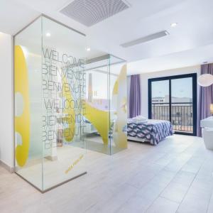 a room with a bed and a glass wall at The Purple Hotel - Adults Only in San Antonio