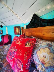 a bedroom with a bed with colorful pillows on it at The Round House in Newton Stewart