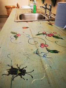 a kitchen counter with a painting of bees on it at The Round House in Newton Stewart