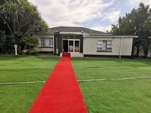 a red carpet on the yard of a house at Selborne Lodge in East London