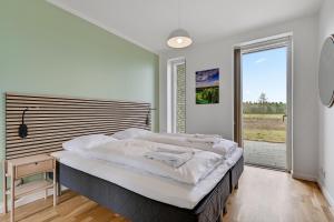 a bedroom with a large bed and a large window at Lübker Golf Resort in Nimtofte +291 photos
