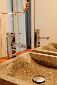 a bathroom with two sinks and a mirror at La Maison de Gruissan in Gruissan