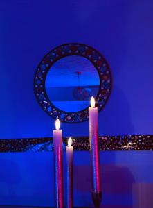 a group of candles in front of a mirror at The Rose Garden Room - self contained studio in Ballycastle