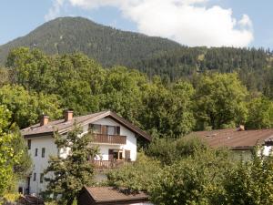 a white house with a balcony in front of a mountain at Ferienwohnung Alpenglück in Garmisch-Partenkirchen