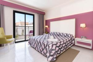 a bedroom with a large bed and a balcony at The Purple Hotel - Adults Only in San Antonio