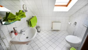 a white bathroom with a sink and a toilet at Cityhotel Magdeburg in Magdeburg +28 photos