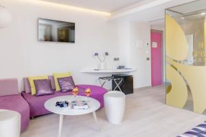 a living room with a purple couch and a table at The Purple Hotel - Adults Only in San Antonio