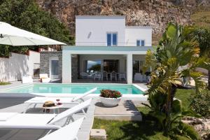 a villa with a swimming pool and a house at Villa Annalisa by PosarelliVillas in Pizzolungo