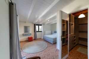 a bedroom with a bed and a door to a room at Villa Louke in Lixouri