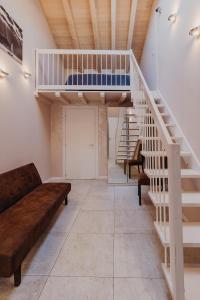 a living room with a staircase and a bunk bed at Le Due Dame in Manerba del Garda