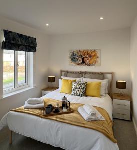 a bedroom with a large bed with a tray on it at Hope House in Swindon