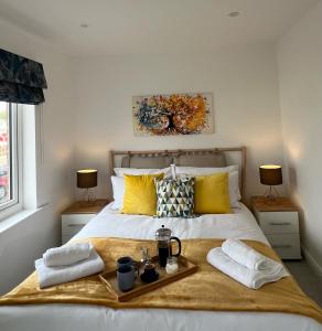 a bedroom with a bed with a tray of food on it at Hope House in Swindon