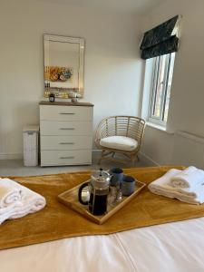 a tray with a tea set on a bed at Hope House in Swindon