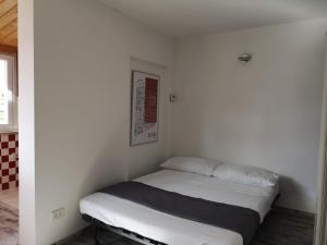 a small bedroom with a bed in the corner at Soulmate Rooftop Apartment in Rome