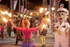 a group of people walking down a street with torches at Porto matrouh chalets in Marsa Matruh